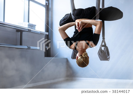 Slim girl practising air-yoga 38144017