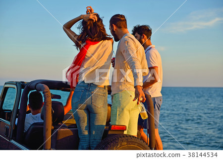 Group of happy friends making party in car - Young 38144534