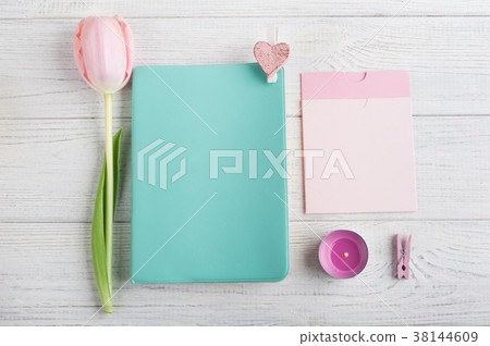 Mint notebook, tulips and lit candle 38144609