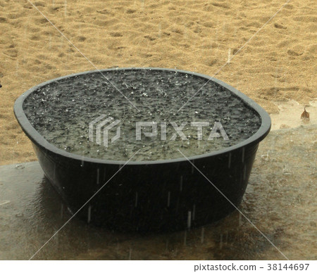 raining on sandy beach with water full basin raining on sandy beach with water full basin 38144697