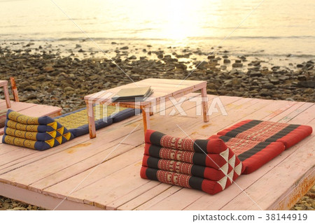 serene asian thai beach cafe with table and mats 38144919