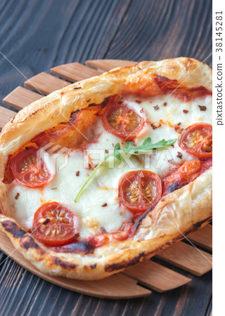 Mini pizza on the wooden board Mini pizza on the wooden board 38145281