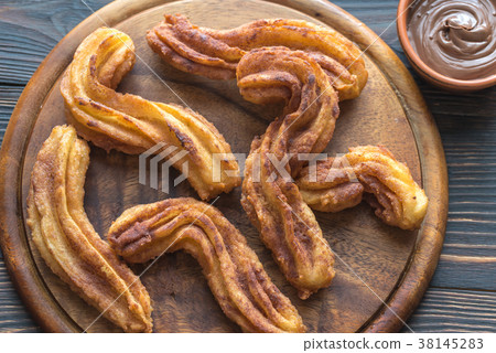 Churros with chocolate sauce Churros with chocolate sauce 38145283
