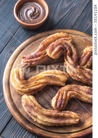Churros with chocolate sauce Churros with chocolate sauce 38145284
