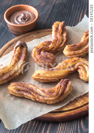 Churros with chocolate sauce Churros with chocolate sauce 38145285