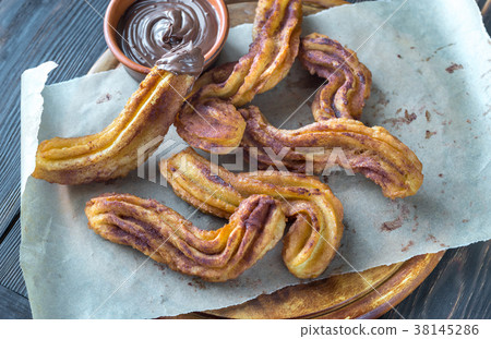 Churros with chocolate sauce Churros with chocolate sauce 38145286