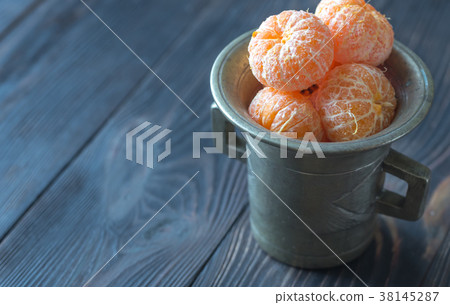 Peeled tangerines in the vintage cup 38145287