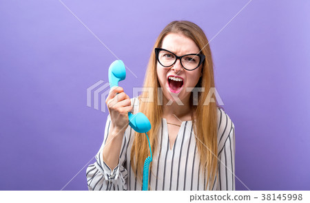 Young woman with old fashioned phone 38145998