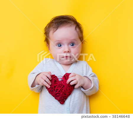little baby with red heart shape toy little baby with red heart shape toy 38146648