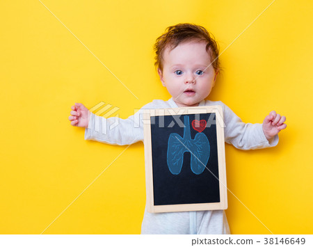 little baby with X-ray board and drawing lungs and heart 38146649