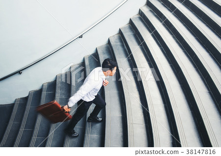 Businessman running fast upstairs Growth up 38147816