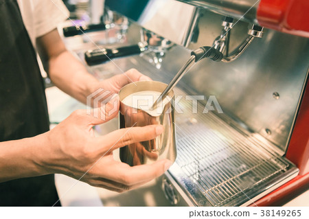 Barista made foam milk by coffee machine. Barista made foam milk by coffee machine. 38149265