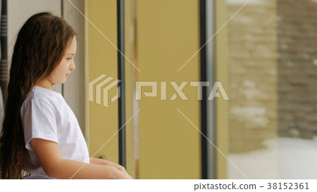 dull leisure idle bored little girl stand window 38152361
