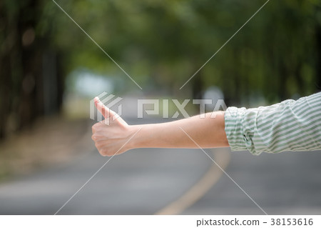 woman hand hitchhiking at countryside road woman hand hitchhiking at countryside road 38153616