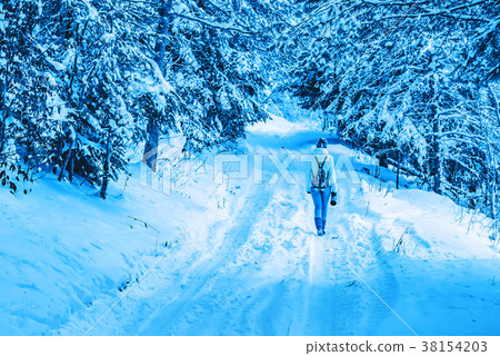 Young female hiker in winter mountain wood 38154203