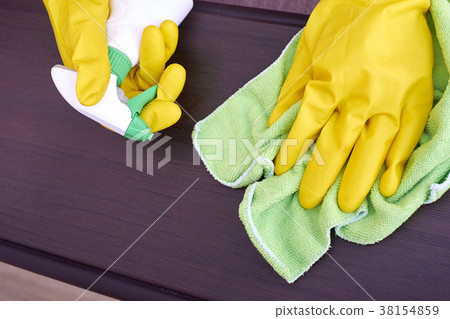 A picture of hands in yellow gloves cleaning the A picture of hands in yellow gloves cleaning the 38154859