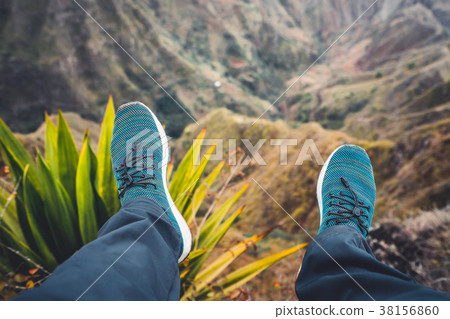 Feet of traveler streching down his legs over Feet of traveler streching down his legs over 38156860
