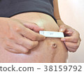 pregnant woman holding  Pregnancy test. 38159792