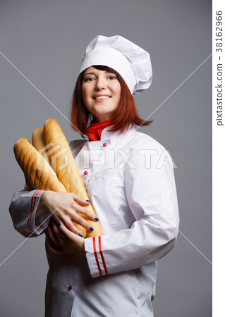 Photo of woman cook in white robe and cap with 38162966