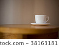 Coffee in a white cup on the table. 38163181