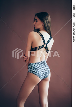 Back view of sexy young woman in swimsuit posing in studio Back view of sexy young woman in swimsuit posing in studio 38163806
