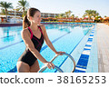 Woman comes out of the sports pool in swimsuit. 38165253