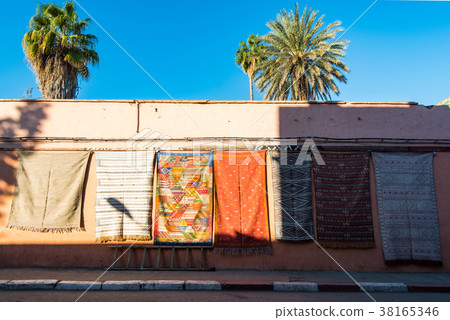 Carpets for sale on the wall in Morocco 38165346