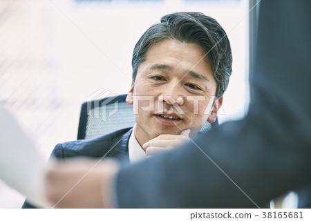 Middle business man looking at materials 38165681