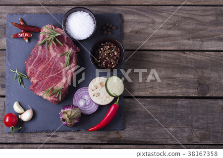Raw meat from black angus with vegetables on the 38167358