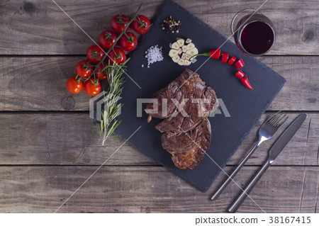 Grilled striploin beef steak with wine glass and 38167415