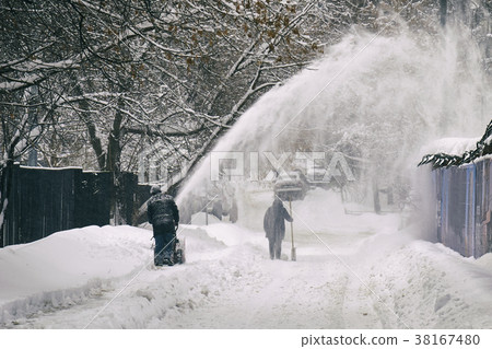 Worker removing snow from the moscow street using Worker removing snow from the moscow street using 38167480