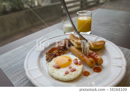 Fork stab on sausage of breakfast 38168109