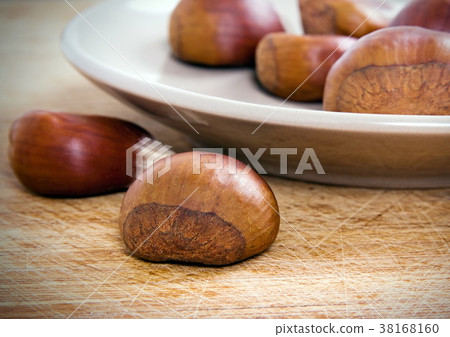 Chestnuts on the table 38168160