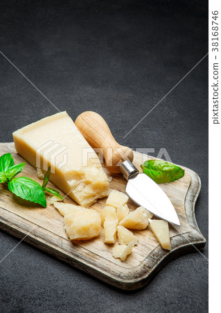 Pieces of parmesan cheese on concrete background 38168746