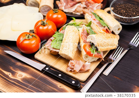 Four sandwiches on wooden board Four sandwiches on wooden board 38170335
