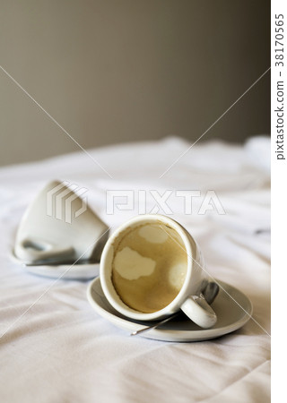 empty cups of coffee on an unmade bed empty cups of coffee on an unmade bed 38170565
