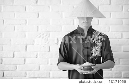 Asian novice on a white brick wall Asian novice on a white brick wall 38171066