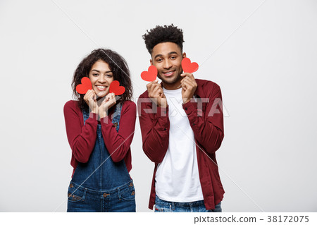 Beautiful Afro American couple holding two red Beautiful Afro American couple holding two red 38172075