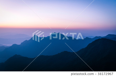 Dark blue mountain ranges with morning skyline Dark blue mountain ranges with morning skyline 38172967