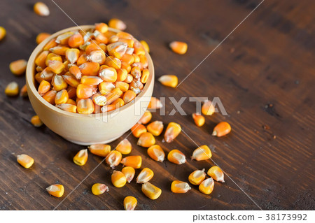 Close up corn seeds in bowl on wooden table Close up corn seeds in bowl on wooden table 38173992