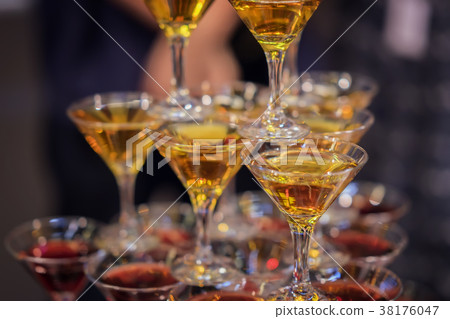 Pyramid of glasses with golden and red beverages Pyramid of glasses with golden and red beverages 38176047