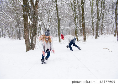 Young people play snowballs in winter forest 38177605