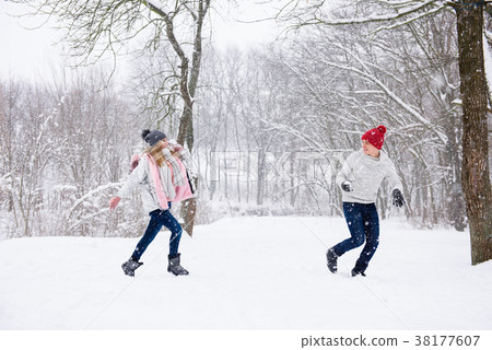 Young people play snowballs in winter forest 38177607