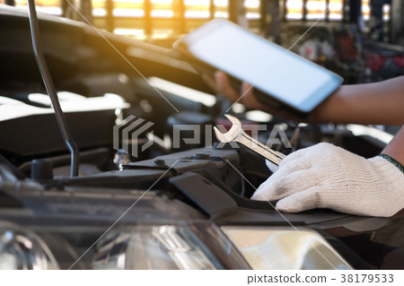 Mechanic repairing a car  in garage  Auto repair  38179533