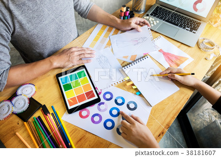 two young women working as fashion designers and drawing sketche 38181607