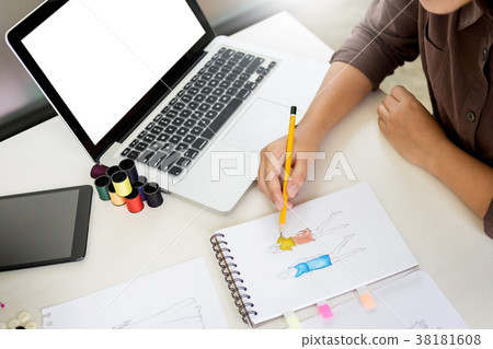 two young men working as fashion designers and drawing sketches 38181608