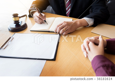 business people and lawyers discussing contract papers sitting a 38181614