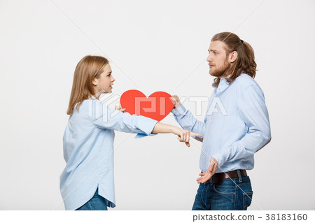 Couple holding heart shape paper with angry facial 38183160