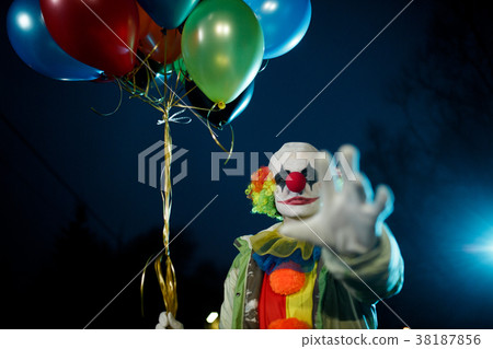 Image of clown with balls in hands at night on 38187856