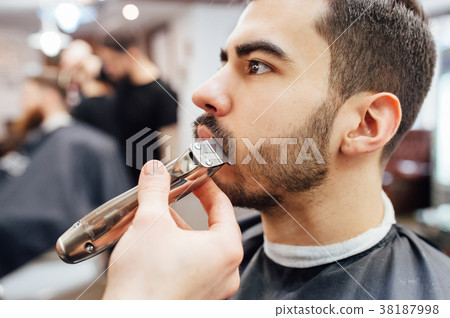 Barber shave and modeling beard at the hair salon Barber shave and modeling beard at the hair salon 38187998